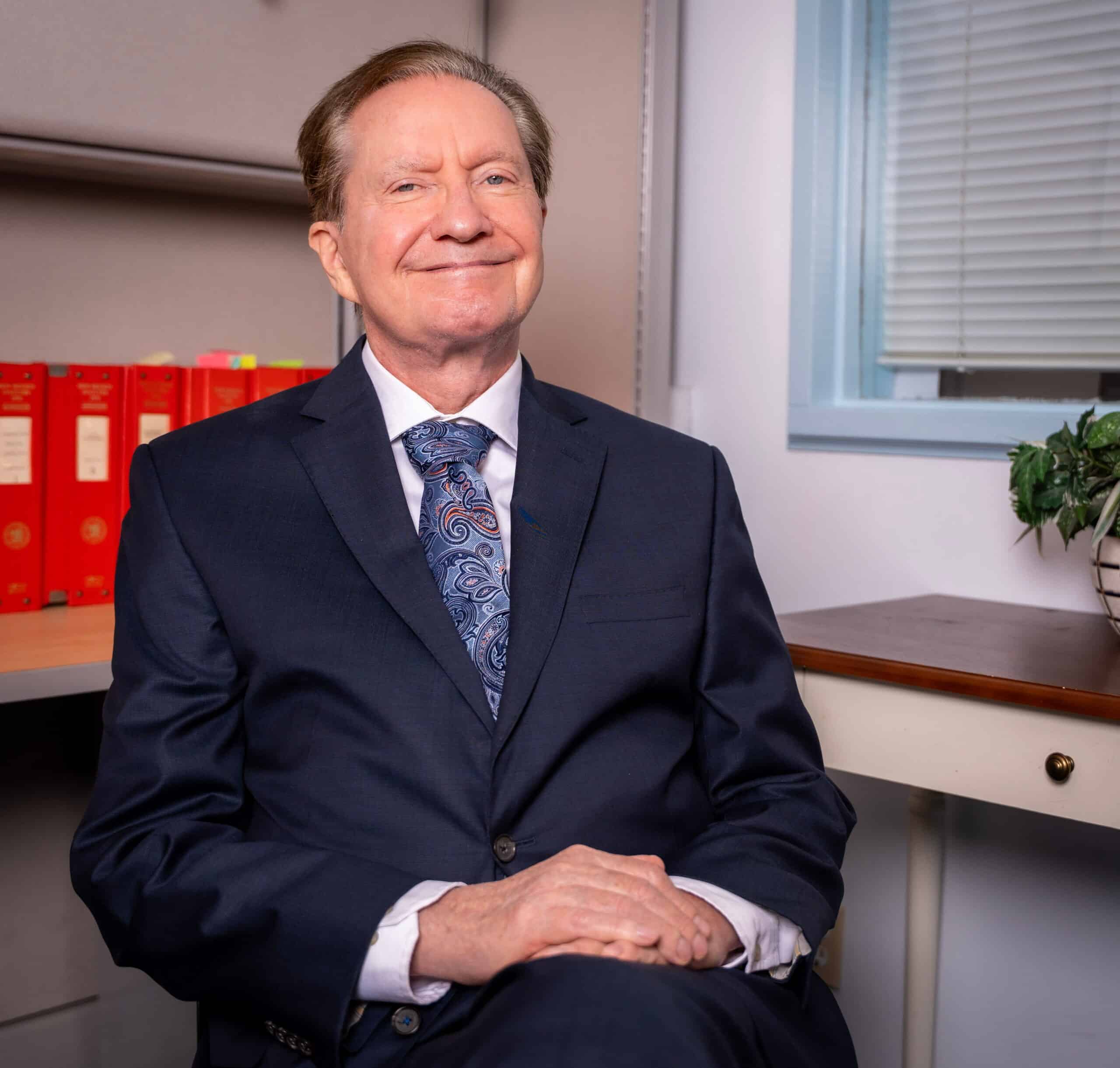 Tim Chelpaty seated at his desk in Las Cruces, New Mexico